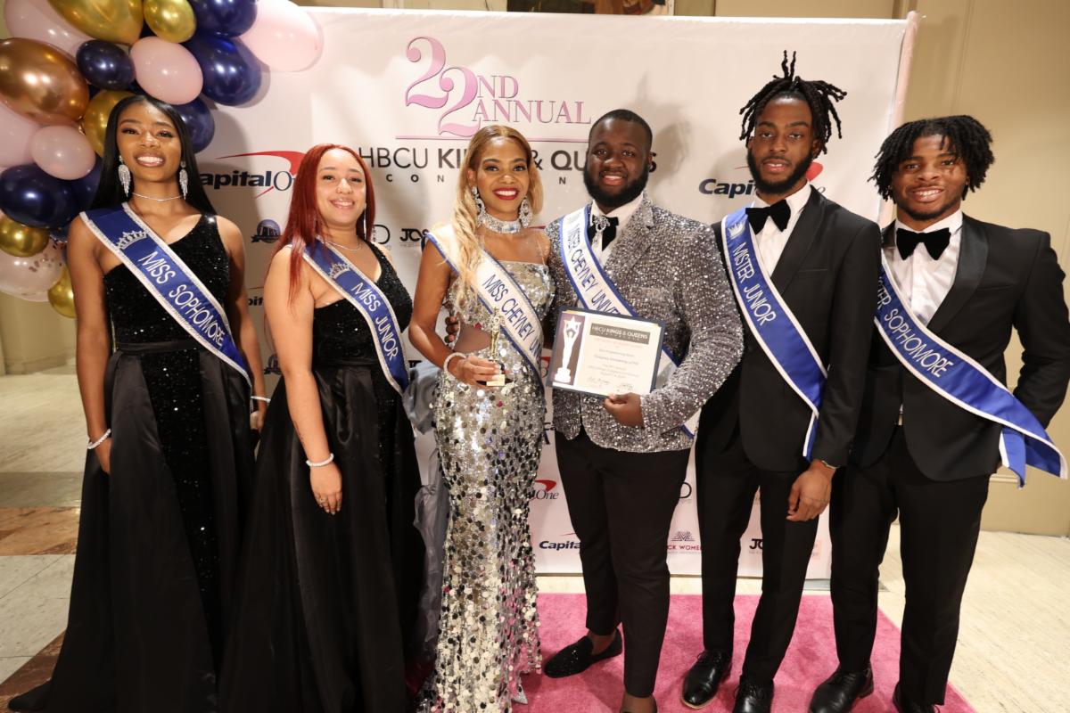Smiling contestants holding a certificate