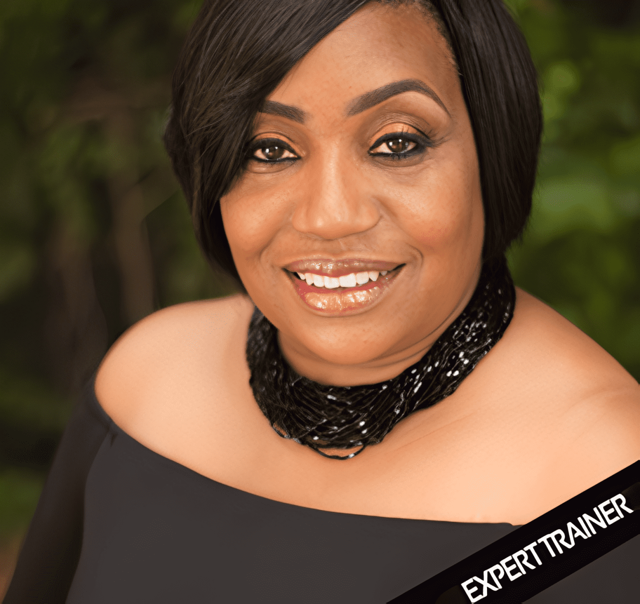 Woman smiling in elegant black outfit