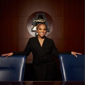 Woman in black suit, office setting