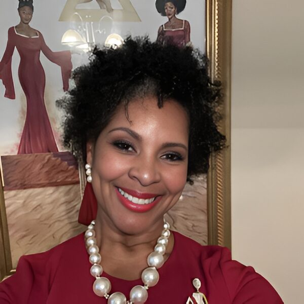 Smiling woman in red dress and pearls