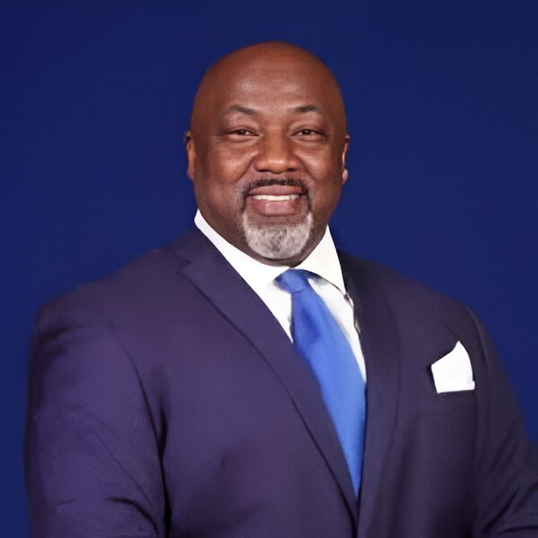 Man in blue suit smiling