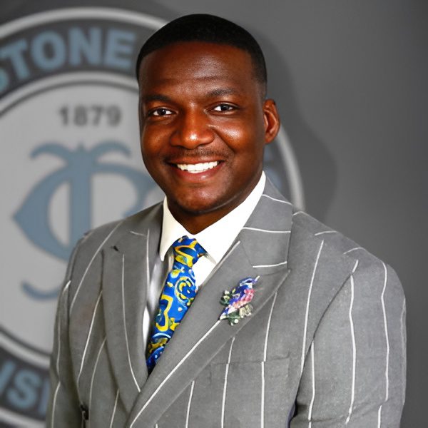 Man in striped suit smiling