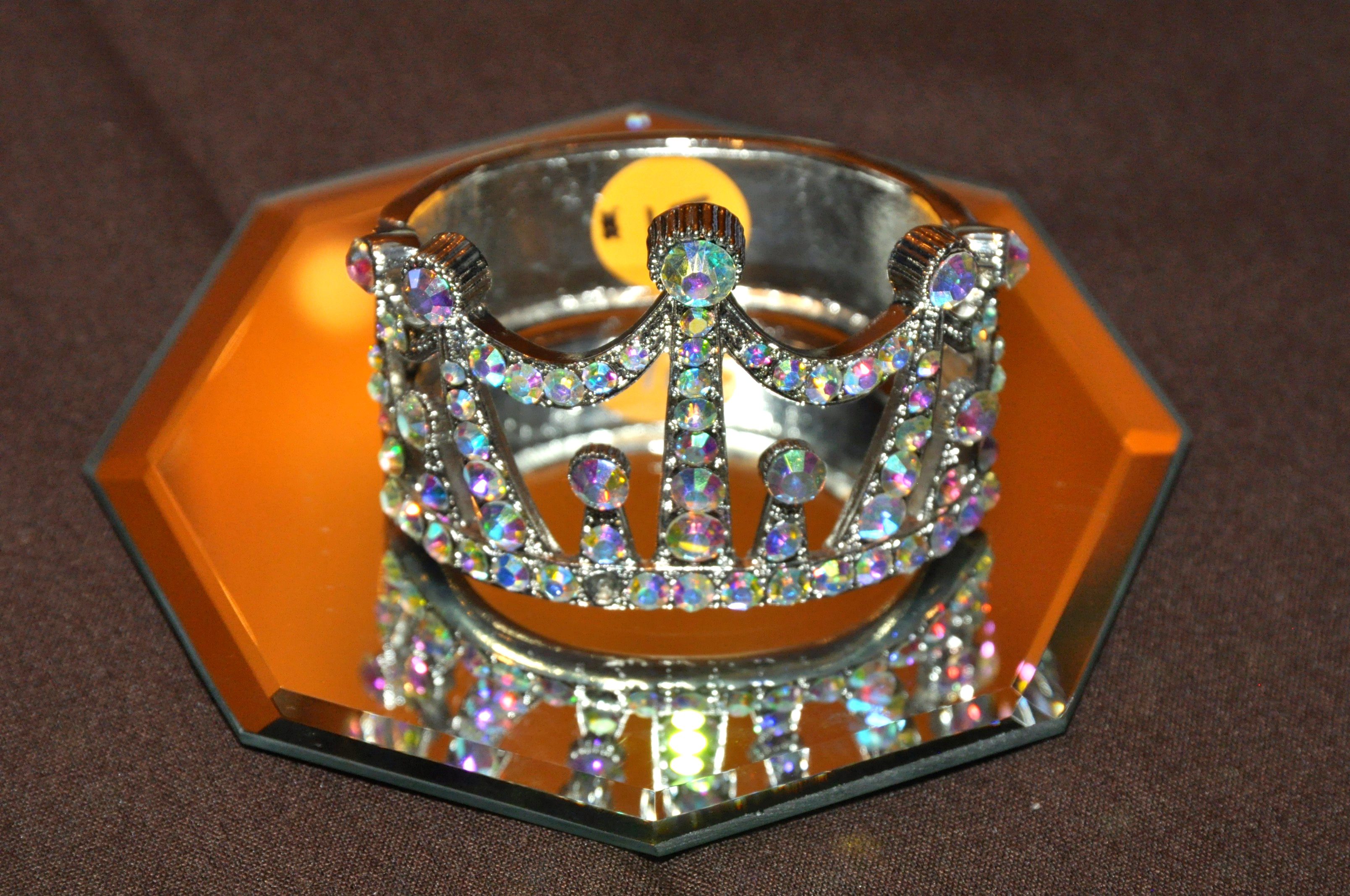 Sparkling crown bracelet on mirrored surface