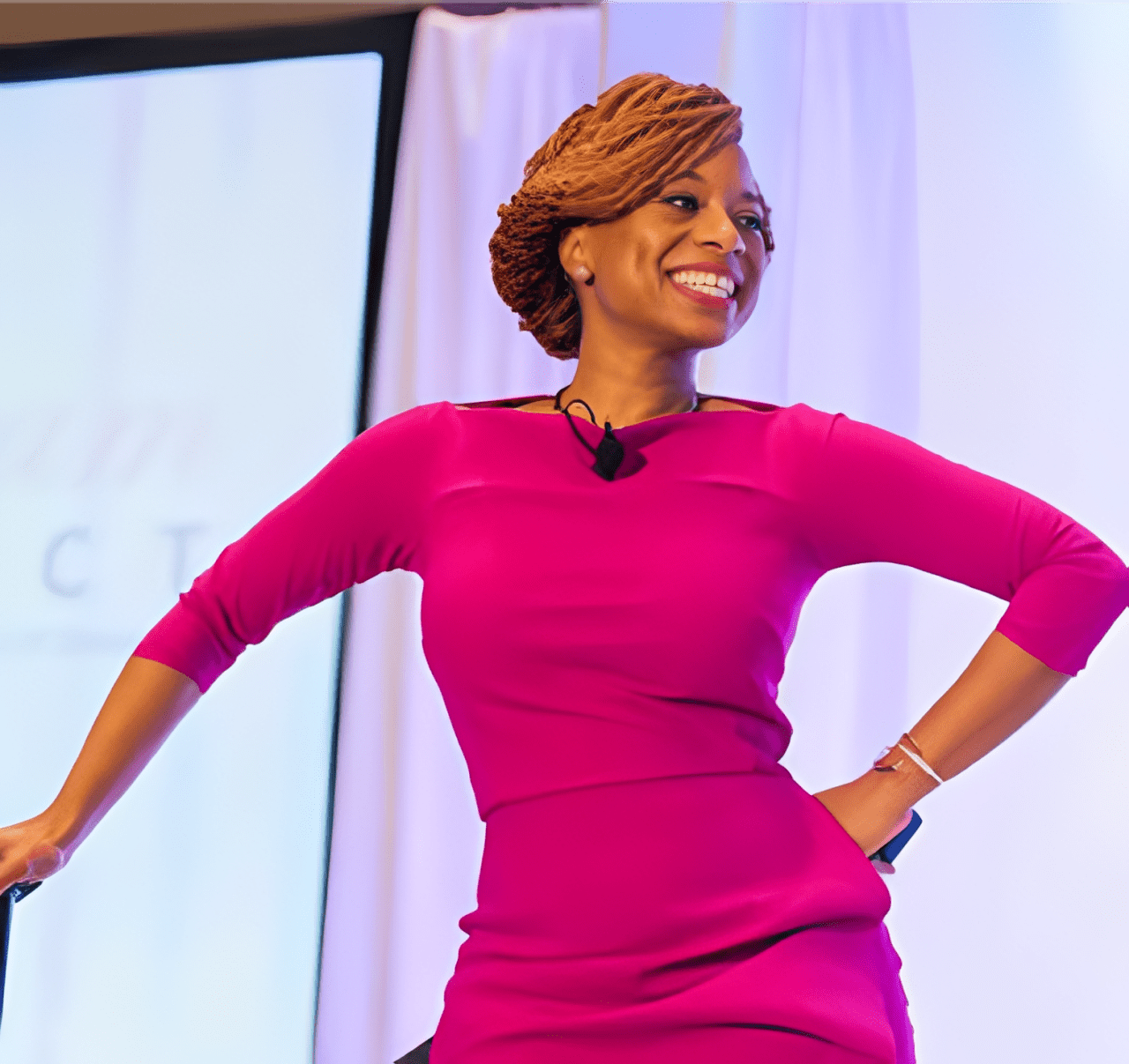 Woman smiling in a bright pink dress