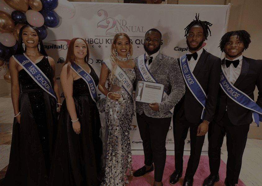 Five people dressed formally at a pageant event.